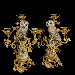 A pair of candelabras with porcelain owl and gilt-bronze vine